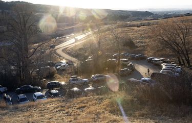 A crowded parking lot by a hiking trail in Bozeman, Mont., on Friday, Nov. 20, 2020. As urbanites flock to forests and rivers to escape coronavirus threats, trailheads are cramped with parked cars and fishing on the Madison River is like a Disneyland ride. (Janie Osborne/The New York Times)