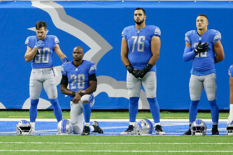 Some of the Detroit Lions during the national anthem before an NFL