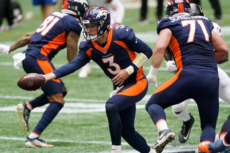 Drew Lock of the Denver Broncos runs out of the pocket against the