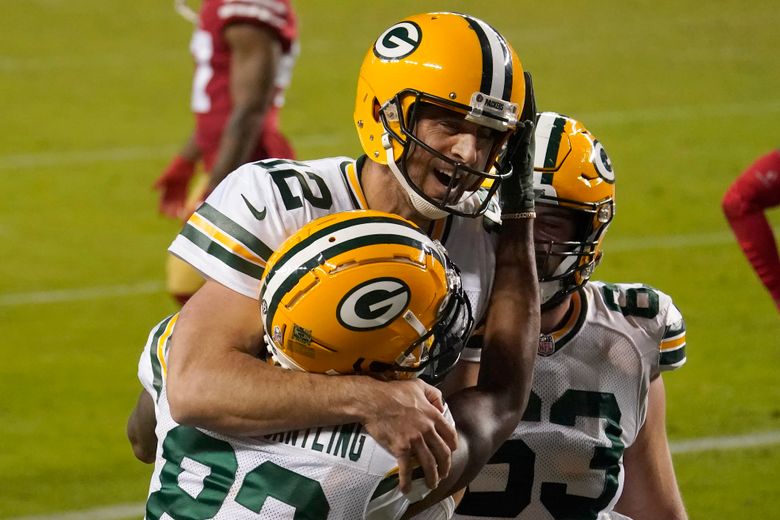 Green Bay Packers quarterback Aaron Rodgers, left, and tackle