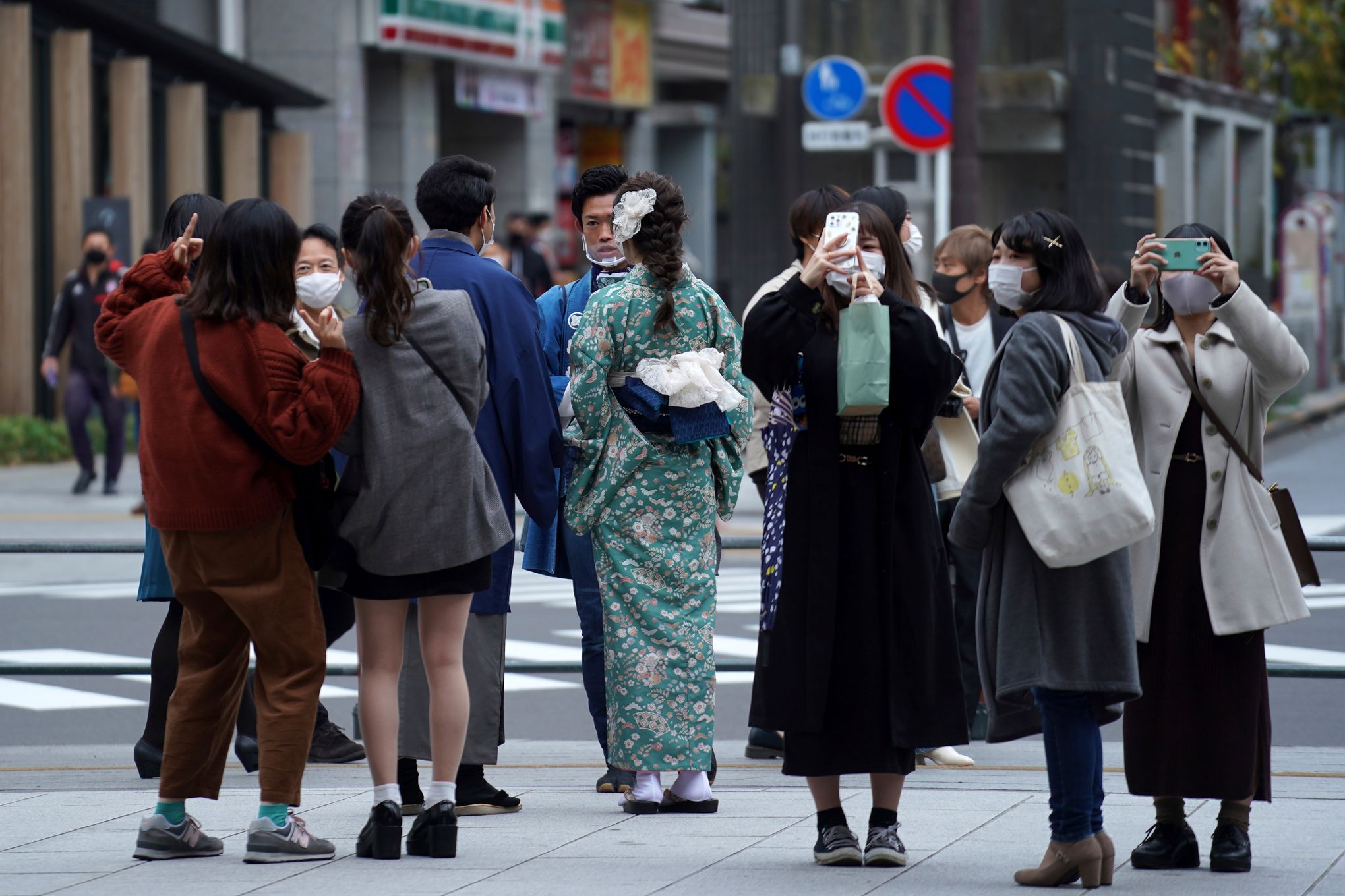 Customers wearing protective face masks strolling close from Chanel store  on the Champs Elysee avenue on May 11, 2020 in Paris, France. France began  a gradual easing of its lockdown measures and