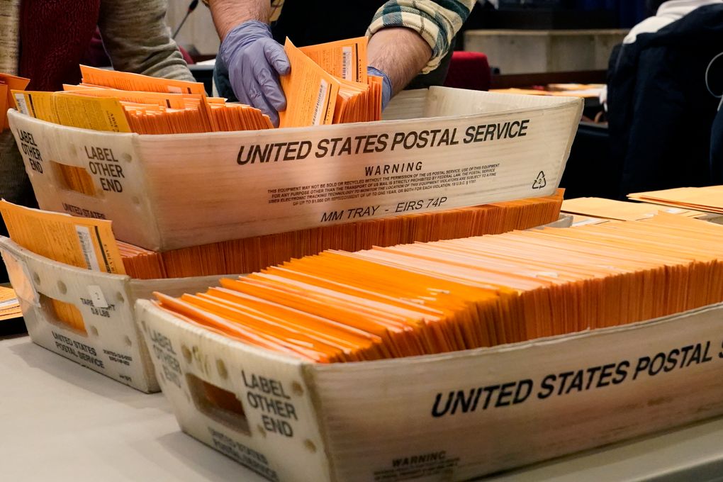 Election officials sort absentee and early voting ballots for counting inside Boston City Hall, Monday, Nov. 2, 2020, in Boston. (Elise Amendola / The Associated Press)