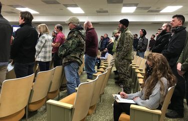 People stand in support of a resolution rejecting Democratic Gov. Ralph Northam’s coronavirus restrictions during a meeting Tuesday of the Campbell County board of supervisors. MUST CREDIT: Washington Post photo by Gregory S. Schneider.