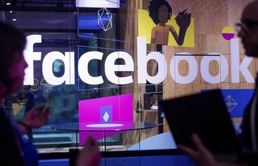 FILE – In this April 18, 2017, file photo, conference workers speak in front of a demo booth at Facebook’s annual F8 developer conference in San Jose, Calif. Facebook said Thursday, Jan. 11, 2018, that it is tweaking what people see to make their time on it more â€œmeaningful.â€ The changes come as Facebook faces criticism that social media can make people feel depressed and isolated. (AP Photo/Noah Berger, File)