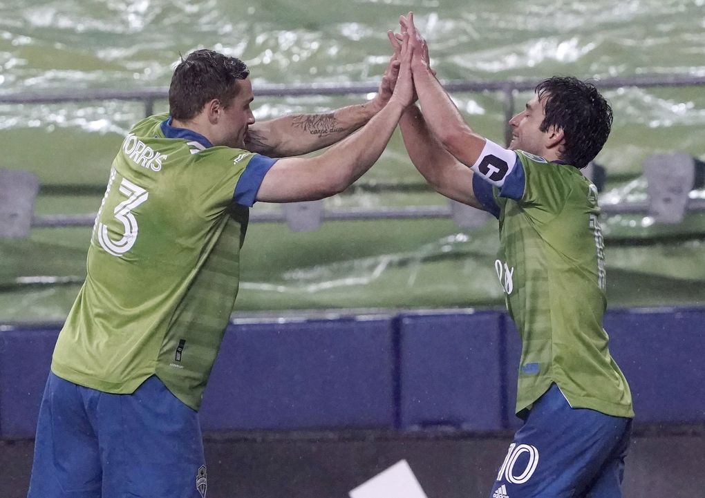 Seattle Sounders’ Nicolas Lodeiro (10) is congratulated on his goal by Jordan Morris (13), who had an assist, during the first half of an MLS playoff soccer match against Los Angeles FC on Tuesday, Nov. 24, 2020, in Seattle. (Ted S. Warren / AP)