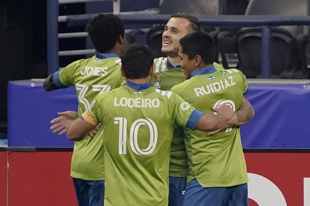Seattle Sounders’ Jordan Morris, back right, celebrates with teammates after he scored his first goal of the first half of the team’s MLS soccer match against the San Jose Earthquakes, Thursday, Sept. 10, 2020, in Seattle. (Ted S. Warren / AP)