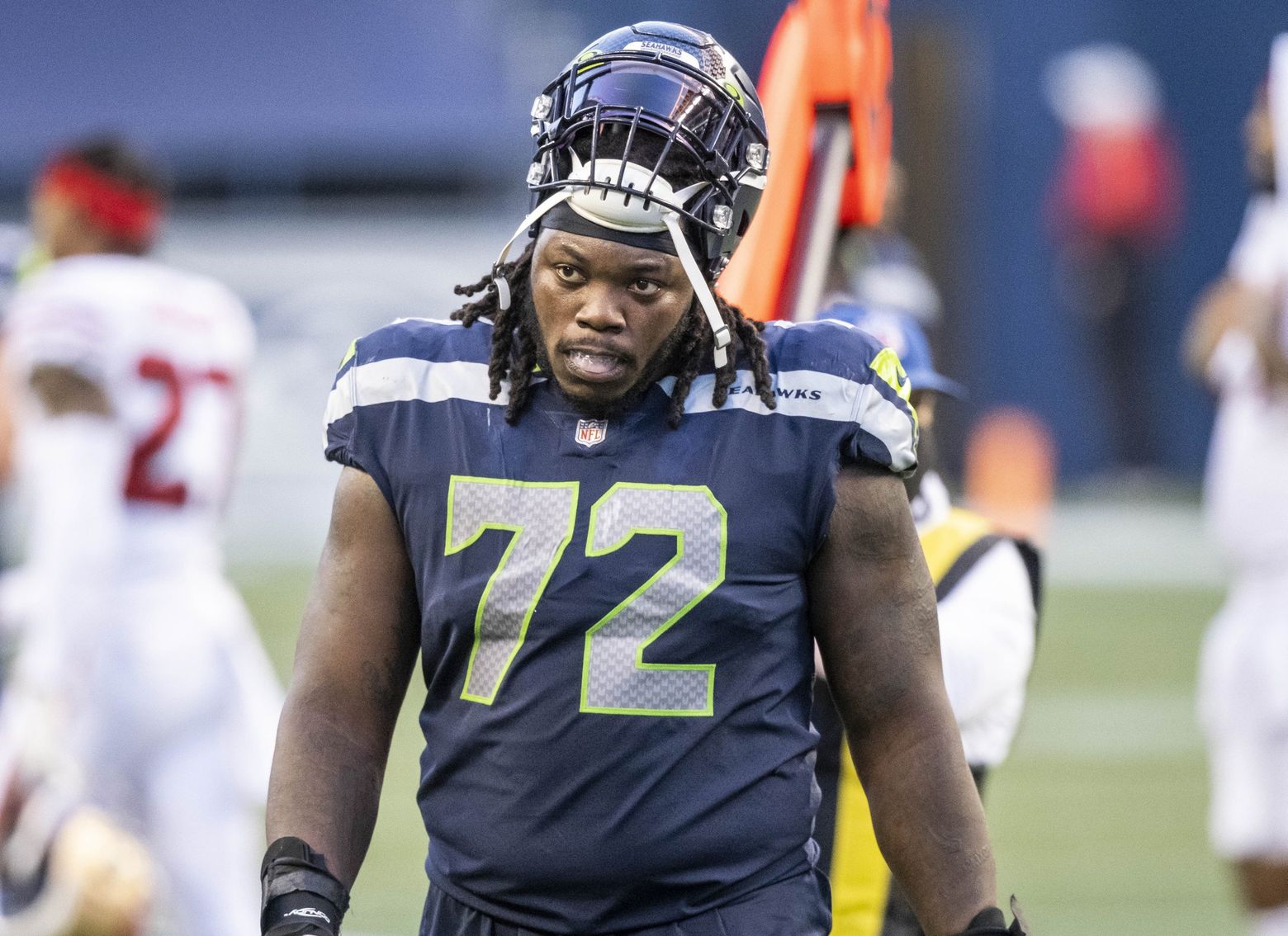 Seattle Seahawks defensive end Carlos Dunlap II (8) wears a decal for the  anniversary of 9-11 on his helmet on the sidelines during an NFL football  game against the Indianapolis Colts, Sunday