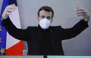 French President Emmanuel Macron is seen on a screen as he attends by video conference a round table for the National Humanitarian Conference (NHC), taken at the Foreign Ministry in Paris,Thursday, Dec. 17, 2020. French President Emmanuel Macron tested positive for COVID-19 Thursday following a week in which he met with numerous European leaders. (Charles Platiau/Pool via AP) PAR134 PAR134