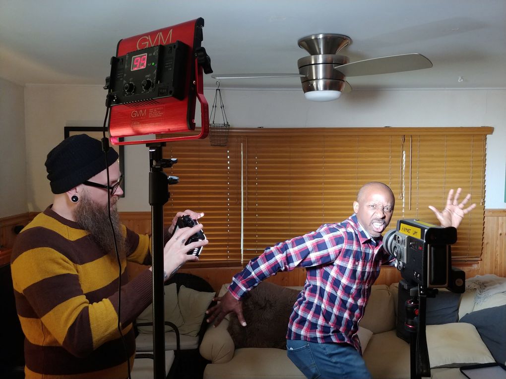 Production team member Jason Austin, left, checks the lighting on the set of Anthony Thambynayagam’s “Figure Man,” starring Willie West, right. The film can be seen at the 9lb Hammer. (Anthony Thambynayagam)