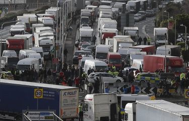 Vehicles wait at the entrance to the Port of Dover, that is blocked by police, as they queue to be allowed to leave, in Dover, England, Wednesday, Dec. 23, 2020. Freight from Britain and passengers with a negative coronavirus test have begun arriving on French shores, after France relaxed a two-day blockade over a new virus variant. The blockade had isolated Britain, stranded thousands of drivers and raised fears of shortages (AP Photo/Frank Augstein) XAG118 XAG118