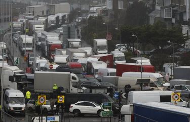 Vehicles wait at the entrance to the Port of Dover, that is blocked by police, as they queue to be allowed to leave, in Dover, England, Wednesday, Dec. 23, 2020. Freight from Britain and passengers with a negative coronavirus test have begun arriving on French shores, after France relaxed a two-day blockade over a new virus variant. The blockade had isolated Britain, stranded thousands of drivers and raised fears of shortages (AP Photo/Frank Augstein) XAG110 XAG110