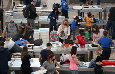 Travelers wear face masks while passing through the south security checkpoint in the main terminal of Denver International Airport Tuesday, Dec. 22, 2020, in Denver. (AP Photo/David Zalubowski) CODZ109 CODZ109