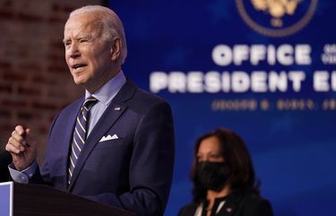 President-elect Joe Biden speaks at The Queen theater, Monday, Dec. 28, 2020, in Wilmington, Del. Vice President-elect Kamala Harris listens at right. (AP Photo/Andrew Harnik) DCAH414 DCAH414