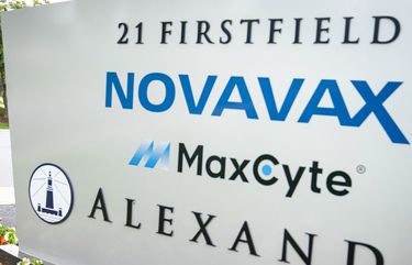A pedestrians walks past signage displayed outside of the Novavax Inc. headquarters in Gaithersburg, Maryland, U.S., on Saturday, Aug. 8, 2020. Novavax shares last week touched a five-year high as investors assessed early data on its experimental vaccine for Covid-19. Photographer: Sarah Silbiger/Bloomberg 775544173