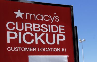 FILE – In this June 25, 2020 file photo, people walk past curbside pickup sign at Macy’s department store in Vernon Hills, Ill. In the days before COVID-19, shopping smart used to mean scoring deals at a department storeâ€™s weekend sale. But the pandemic has led to a shift in consumer habits. Now, many consumers are making their purchases online for home delivery or picking them up curbside. To save money while shopping during the pandemic, sign up for in-stock alerts, lean on your community, read reviews carefully and more.  (AP Photo/Nam Y. Huh, File) NYBZ201 NYBZ201