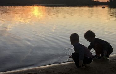 This image provided by Lucy O’Donoghue shows a children playing by a lake. Although this year’s quarantine limited Lucy O’Donoghue’s opportunities for travel, she found ways to focus on her two sons by taking them for ‘micro-holidays’ at a beach near their Georgia home. (Lucy O’Donoghue via AP) LENT104 LENT104