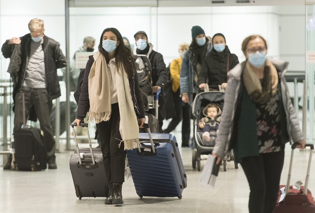 Passengers arrive at Montreal-Trudeau Airport in Montreal on Tuesday, Dec. 29, 2020. (Graham Hughes / The Canadian Press via AP)