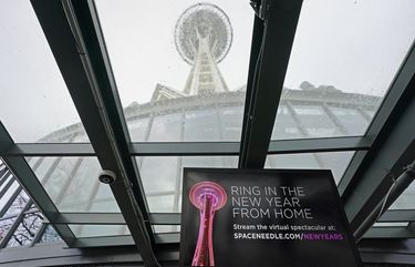 A video display at Space Needle tells visitors that the landmark’s usual in-person fireworks display on New Year’s Eve will instead be a virtual display streamed on the internet, Wednesday, Dec. 30, 2020, in Seattle. The coronavirus scourge that dominated the 2020 is also looming over New Year’s festivities and forcing officials worldwide to tone them down. From New York’s Times Square to Sydney Harbor, big public blowouts are being turned into TV-only shows and digital events. (AP Photo/Ted S. Warren) WATW102 WATW102