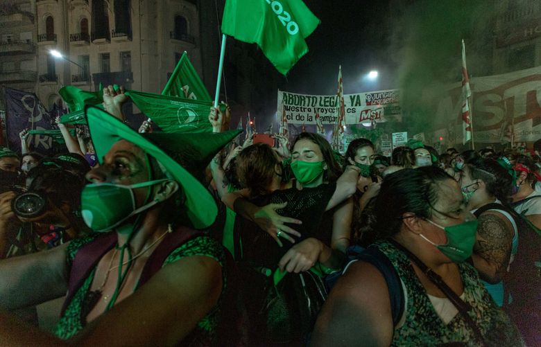 Supporters of legalizing abortion celebrating outside Congress in Buenos Aires, Argentina, on Wednesday, Dec. 30, 2020, after Argentina became the largest nation in Latin America to legalize abortion. (Sarah Pabst/The New York Times)