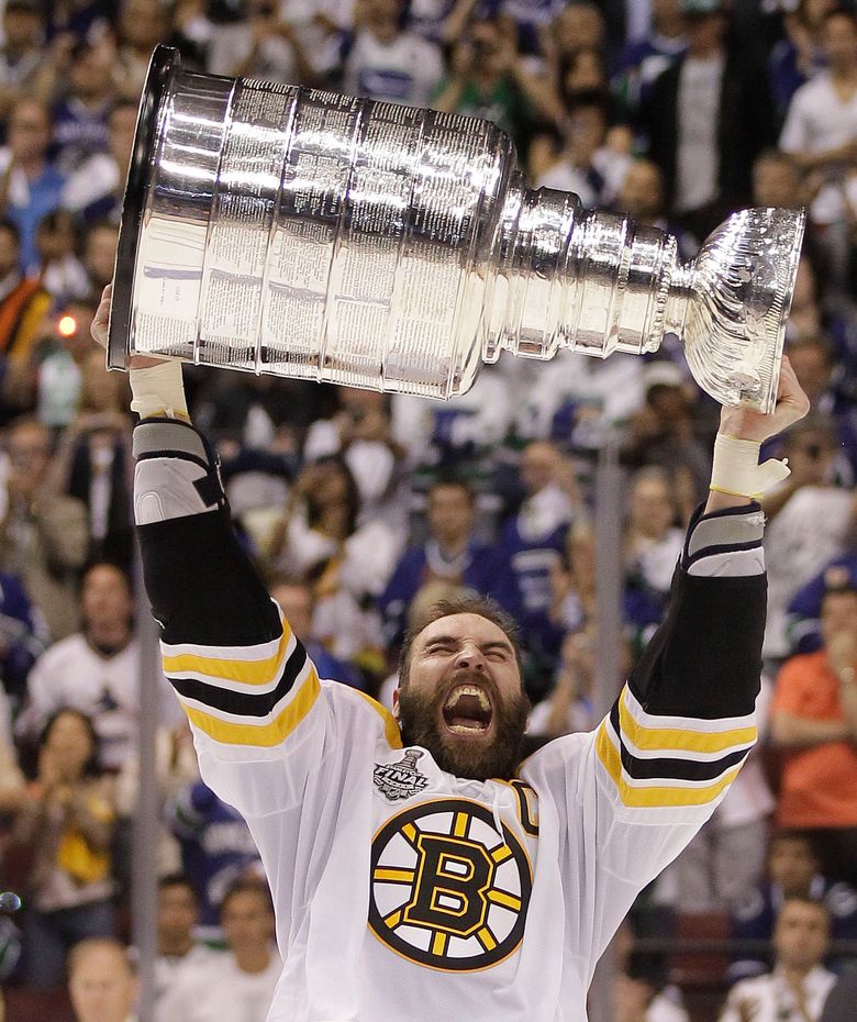 Boston Bruins captain Zdeno Chara hoists the Stanley Cup
