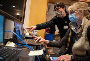 IT staff help clinical providers set up new computers at the University of Vermont Medical Center in Burlington after an October cyberattack took down many critical systems. (Ryan Mercer/University of Vermont Health Network via AP)