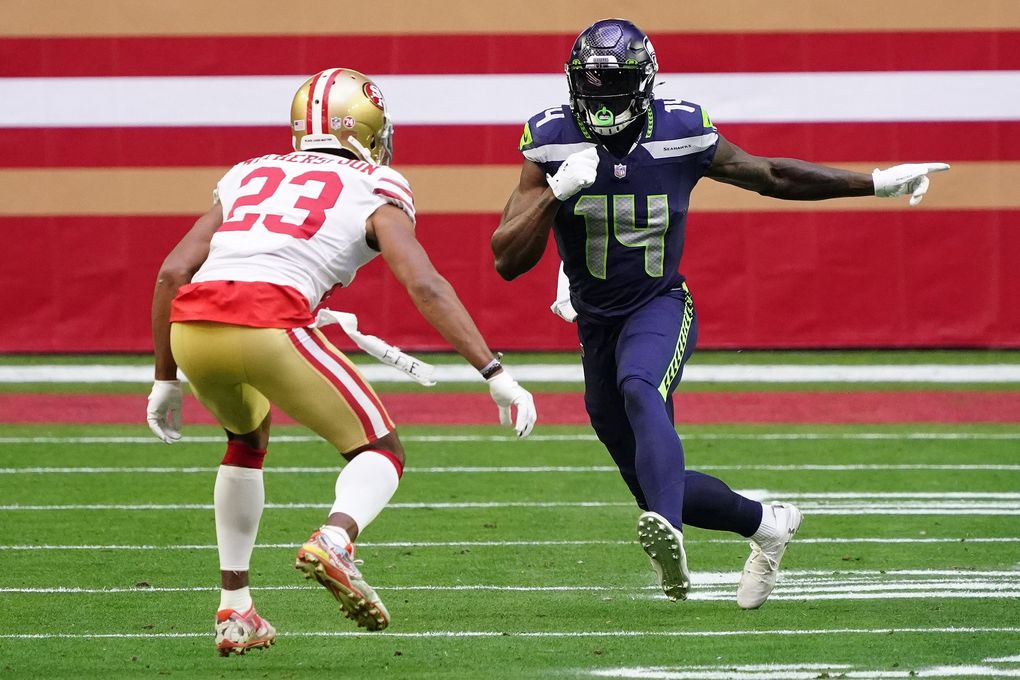 Seahawks wide receiver DK Metcalf (14) runs a route against San Francisco 49ers cornerback Ahkello Witherspoon (23) in the first quarter Sunday in Glendale, Ariz. (Rick Scuteri / The Associated Press)