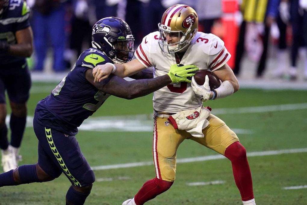 San Francisco 49ers quarterback C.J. Beathard (3) is sacked by Seahawks defensive end Benson Mayowa on Sunday in Glendale, Ariz. (Ross D. Franklin / The Associated Press)