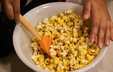 Mix any additional toppings you have added to the popcorn.