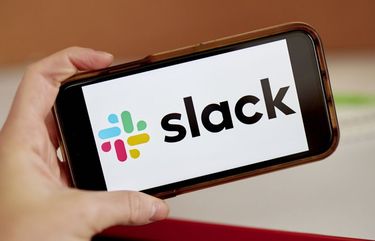 Slack signage on a smartphone in the Brooklyn Borough of New York, U.S., on Tuesday, Dec. 1, 2020. Salesforce.com’s expected purchase of Slack Technologies Inc. will likely be valued in the high $20 billions, according to the WSJ. Photographer: Gabby Jones/Bloomberg