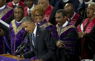 FILE – In this June 26, 2015, file photo, President Barack Obama sings “Amazing Grace” during services honoring the life of Rev. Clementa Pinckney, at the College of Charleston TD Arena in Charleston, S.C. In moments of crisis, American presidents have sought to summon words to match the moment in the hope that the power of oratory can bring order to chaos and despair. (AP Photo/Carolyn Kaster, File) WX203 WX203