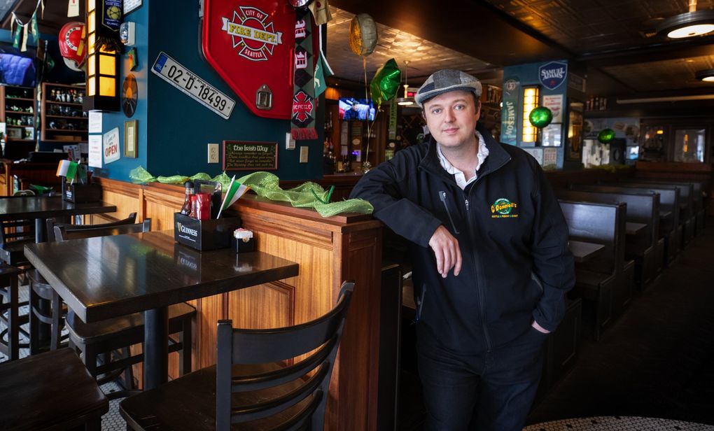 Shawn O’Donnell, Jr., the owner of Shawn O’Donnell’s American Grill and Irish Pub in Pioneer Square, stands in his nearly empty restaurant March 11, 2020. At that time, he said the place is usually much fuller and the coronavirus scare had cut his business by 61%. He and his family also own three other pubs in Fremont, Everett and Spokane. He’s now trying to hold on to secure a second PPP loan. (Ellen M. Banner / The Seattle Times)