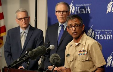 At a press conference at the State of Washington’s Department of Health Public Health Laboratories, Tuesday, January 21, 2020, Dr. Satish Pillai, Center for Disease Control, Atlanta, GA, and other health professionals gave a briefing of what they know in the early stage of the first confirmed case of 2019 novel coronavirus in a Snohomish County resident.
Looking on at left is Dr John Wiesman, Secretary of Health, Washington State Dept. of Health and Gov Jay Inslee. 212735