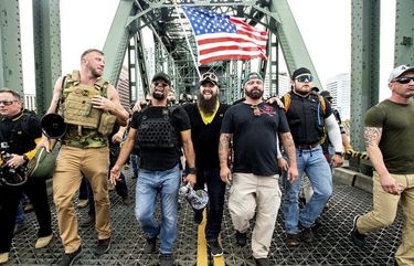 FILE – Members of the Proud Boys, including organizer Joe Biggs, third from right, march across the Hawthorne Bridge during an “End Domestic Terrorism” rally in Portland, Ore., on Saturday, Aug. 17, 2019.  Biggs was arrested Wednesday, Jan. 20, 2021 for taking part in the siege of the U.S. Capitol earlier this month, authorities said. Biggs, 37, was arrested in central Florida and faces charges of obstructing an official proceeding before Congress, entering a restricted on the groups of the U.S. Capitol and disorderly conduct. (AP Photo/Noah Berger, file) NYPS206 NYPS206