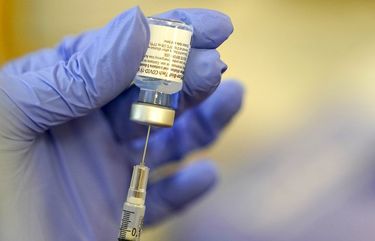 A pharmacist prepares a syringe of the Pfizer vaccine for COVID-19 on Jan. 8 at Queen Anne Healthcare in Seattle. (AP Photo/Ted S. Warren) WATW107