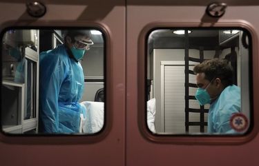 Emergency medical technician Thomas Hoang, left, of Emergency Ambulance Service, and paramedic Trenton Amaro prepare to unload a COVID-19 patient from an ambulance in Placentia, Calif., Friday, Jan. 8, 2021. EMTs and paramedics have always dealt with life and death — they make split-second decisions about patient care, which hospital to race to, the best and fastest way to save someone — and now they’re just a breath away from becoming the patient themselves. (AP Photo/Jae C. Hong)