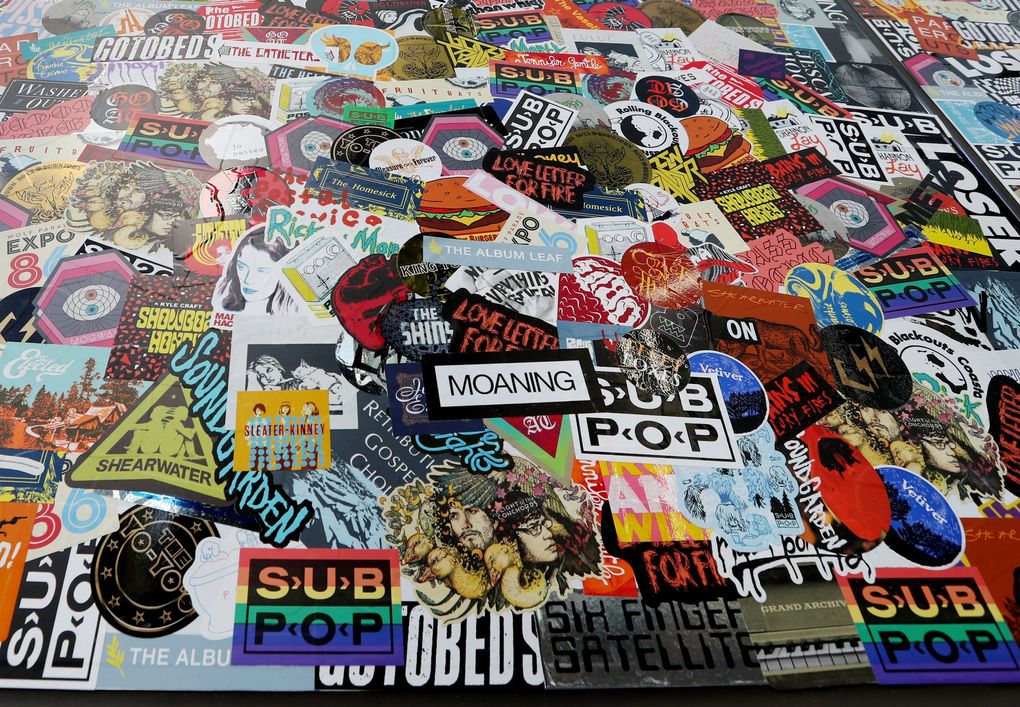 Sub Pop on 7th’s external sticker wall, where local bands are encouraged to slap their adhesive promo materials, adds a little rock ‘n’ roll color to the neighborhood. (Ken Lambert / The Seattle Times)