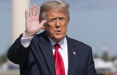 Former President Donald Trump waves to the members of the media on arrival at Palm Beach International Airport in West Palm Beach, Fla., Wednesday, Jan. 20, 2021. (AP Photo/Manuel Balce Ceneta) FLMC218 FLMC218