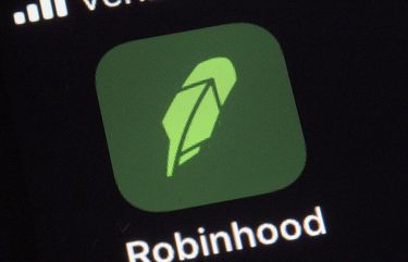 FILE – This  Dec. 17, 2020 file photo shows the logo for the Robinhood app on a smartphone in New York.  The online trading platform Robinhood is moving to restrict trading in GameStop and other stocks that have soared recently due to rabid buying by smaller investors.    (AP Photo/Patrick Sison) NYBZ503 NYBZ503