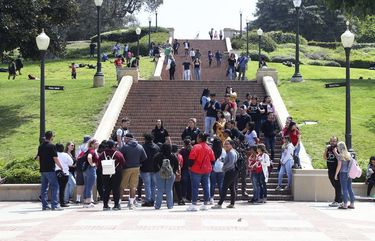 People move about the campus of the University of California, Los Angeles Friday, April 26, 2019. Some students and employees possibly exposed to measles at two Los Angeles universities were still quarantined on campus or told to stay home Friday, but the numbers were dwindling as people were able to show they were vaccinated for the highly contagious disease. The measures were ordered this week at UCLA and California State University, Los Angeles. (AP Photo/Reed Saxon)