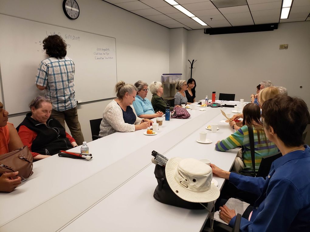 Members of the Low Vision Book Group gather at Seattle Public Library for a meeting in June 2019. (Cleo Brooks)