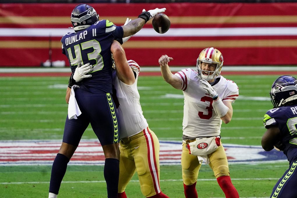 San Francisco 49ers quarterback C.J. Beathard (3) has his pass blocked by Seattle Seahawks defensive end Carlos Dunlap (43) during the first half of an NFL football game, Sunday, Jan. 3, 2021, in Glendale, Ariz. (AP Photo/Rick Scuteri) AZMY125 AZMY125 (Rick Scuteri / The Associated Press)