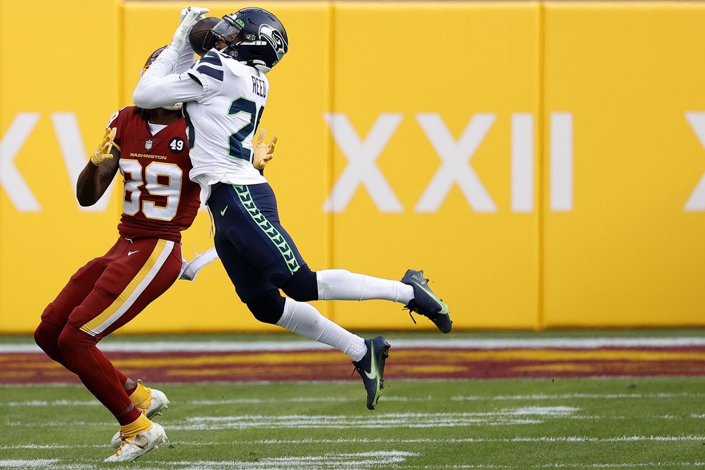 LANDOVER, MARYLAND – DECEMBER 20: Free safety D.J. Reed #29 of the Seattle Seahawks intercepts a pass intended for wide receiver Cam Sims #89 of the Washington Football Team in the second half at FedExField on December 20, 2020 in Landover, Maryland. (Photo by Tim Nwachukwu/Getty Images) (Tim Nwachukwu / Getty Images)