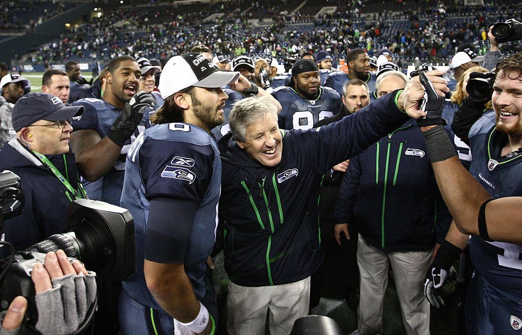 Seattle head coach Pete Carroll, center at right, stands triumphant with his quarterback Charlie Whitehurst after defeating St. Louis 16-6 on Sunday, January 2, 2011, at Qwest Field in Seattle, Wash. (John Lok / The Seattle Times)