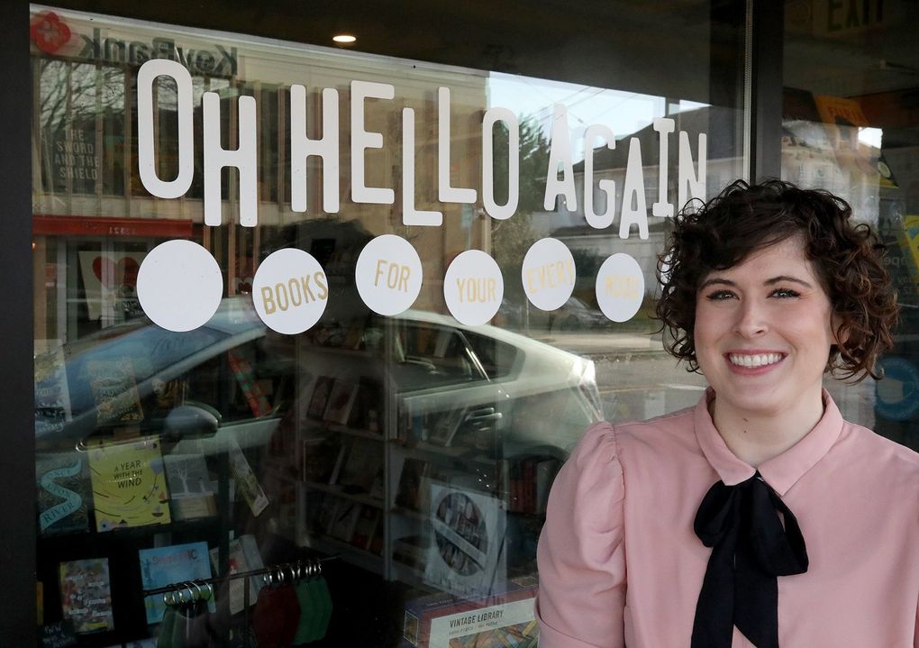 Kari Ferguson, owner of Oh Hello Again, has organized the shelves in Seattle’s not by traditional categories like genre and era but by emotion. (Greg Gilbert / The Seattle Times)