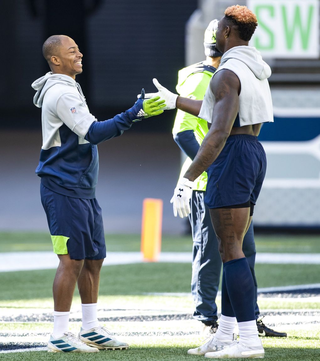 Seahawks wide receivers Tyler Lockett and DK Metcalf do their special pregame handshake as the Seattle Seahawks take on the San Francisco 49ers at CenturyLink Field in Seattle Sunday November 1, 2020. (Bettina Hansen / The Seattle Times)