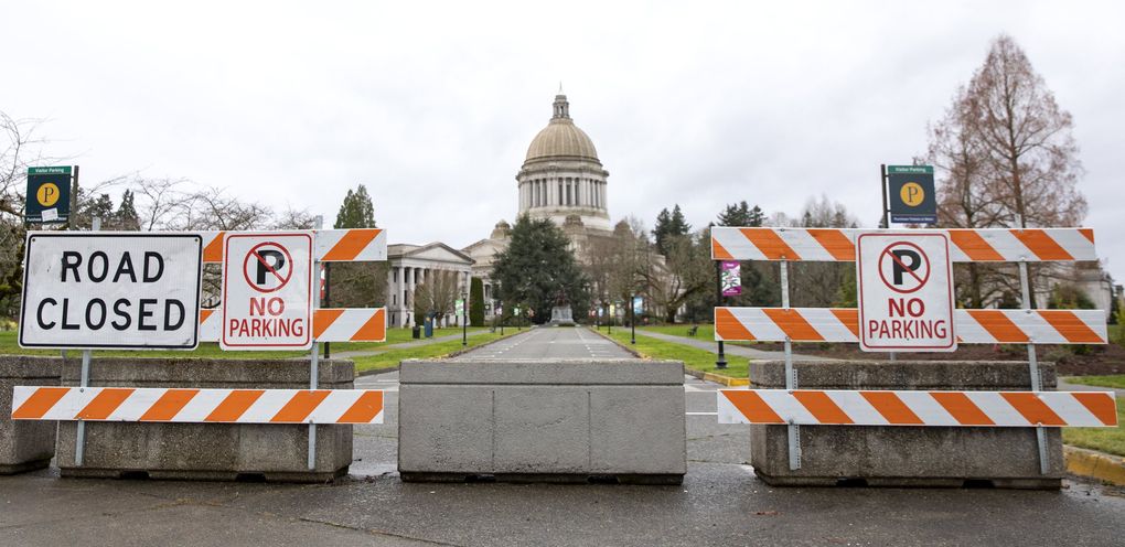 Barricades block entrances to the closed Capitol campus last month. (Bettina Hansen / The Seattle Times)