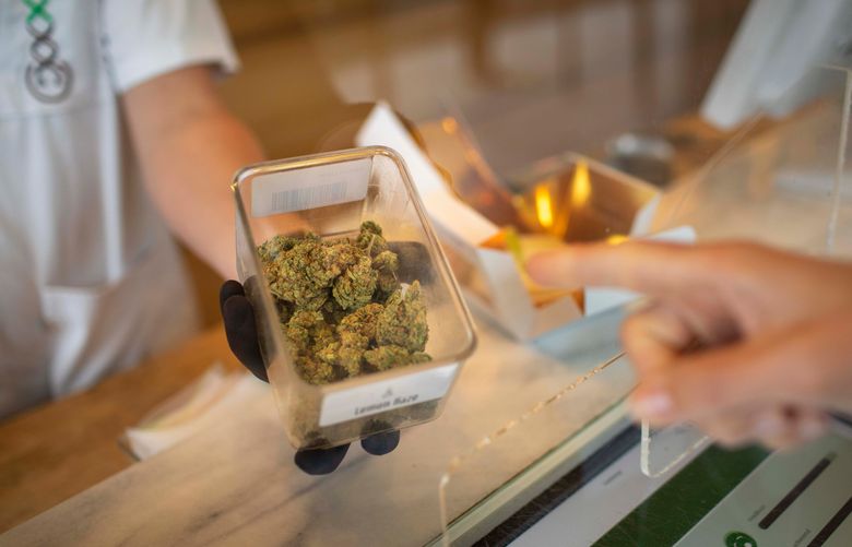 FILE -- Employees sell marijuana at Boerejongens, a coffee shop in Amsterdam, Nov. 2 2020. Amid an increasingly difficult relationship with 