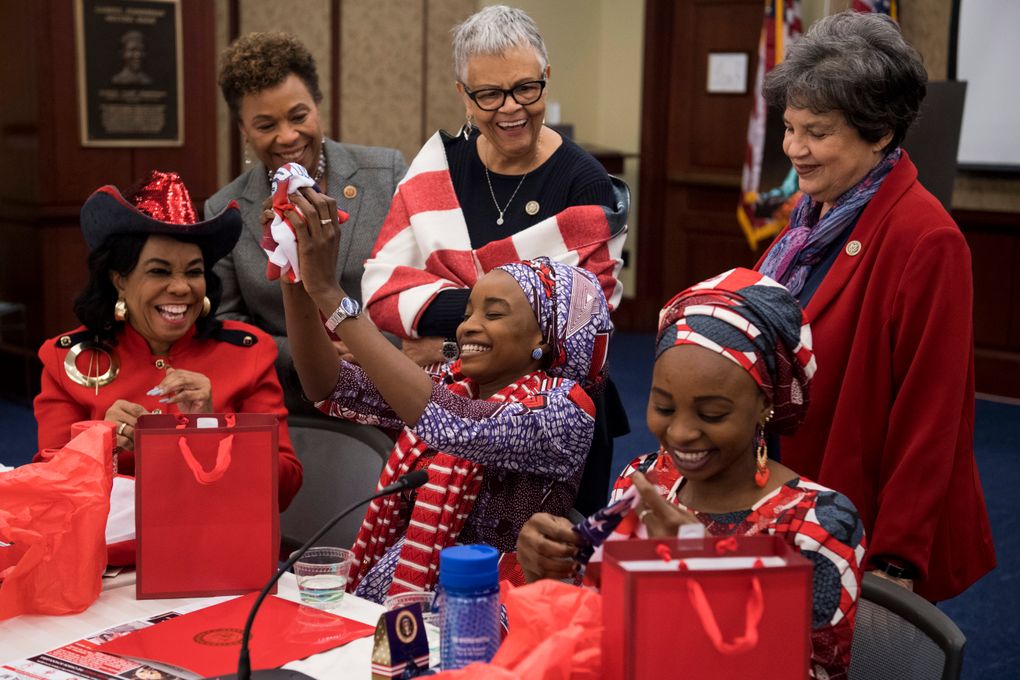 From left, Reps. Frederica S. Wilson, Barbara Lee, Bonnie Watson Coleman and Lois Frankel gather around as Ya Kaka and Hauwa open their gifts after a roundtable discussion about gender-based violence hosted by Wilson at the U.S. Capitol in Washington on March 7, 2018. (Carolyn Van Houten / Washington Post)