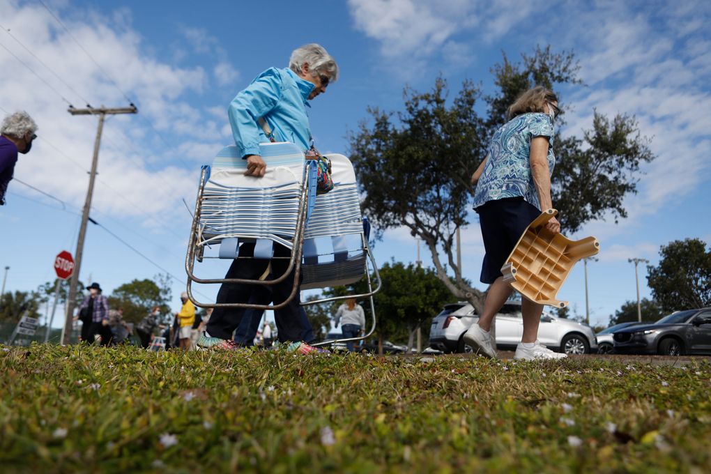 FILE — People queue for COVID-19 vaccinations at a sports complex in Fort Myers, Fla., Dec. 29, 2020. Florida decided people 65 and older should get the coronavirus vaccine first but demand has overwhelmed supply, and people are frustrated. (Octavio Jones / The New York Times)