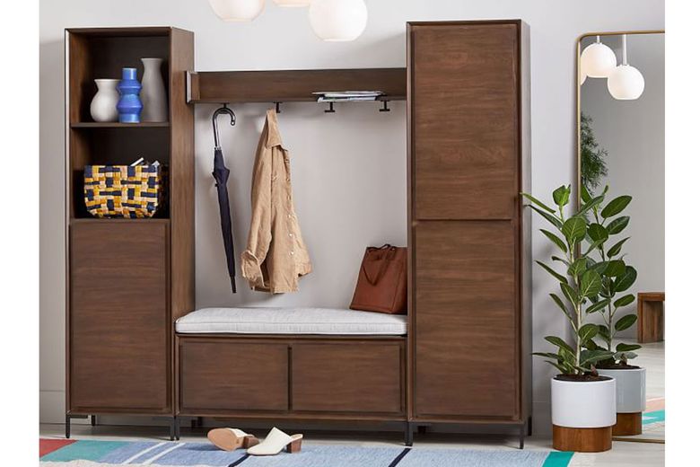 Storage you can close conceals clutter in an entry and a bench provides seating and additional storage, as seen in West Elm’s customizable Nolan system. (Courtesy of West Elm) 